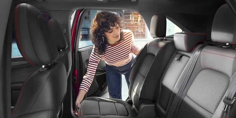 Interior view of a person getting into a 2024 Ford Escape