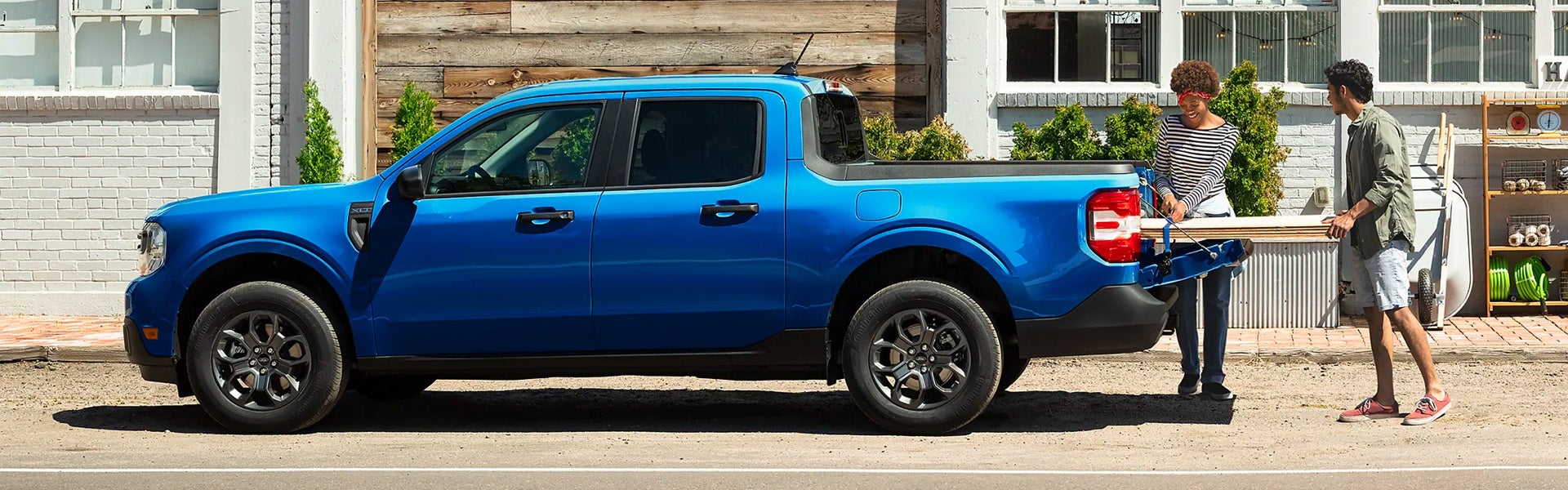 Photo of a blue 2024 Ford Maverick driving on the road