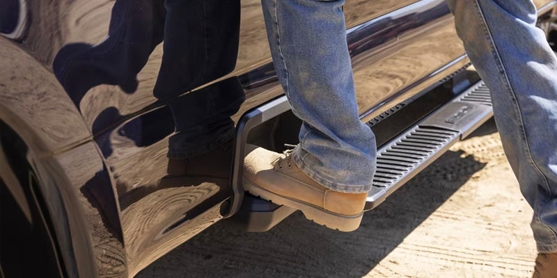 Photo of a person stepping on the door of a 2024 Ford Super Duty