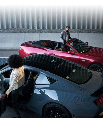Two people exiting their parked 2024 Ford Mustang® coupe and convertible | Al Packer's White Marsh Ford in Middle River MD