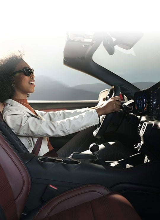 Person sitting in the driver’s seat of a 2024 Ford Mustang® convertible | Al Packer's White Marsh Ford in Middle River MD