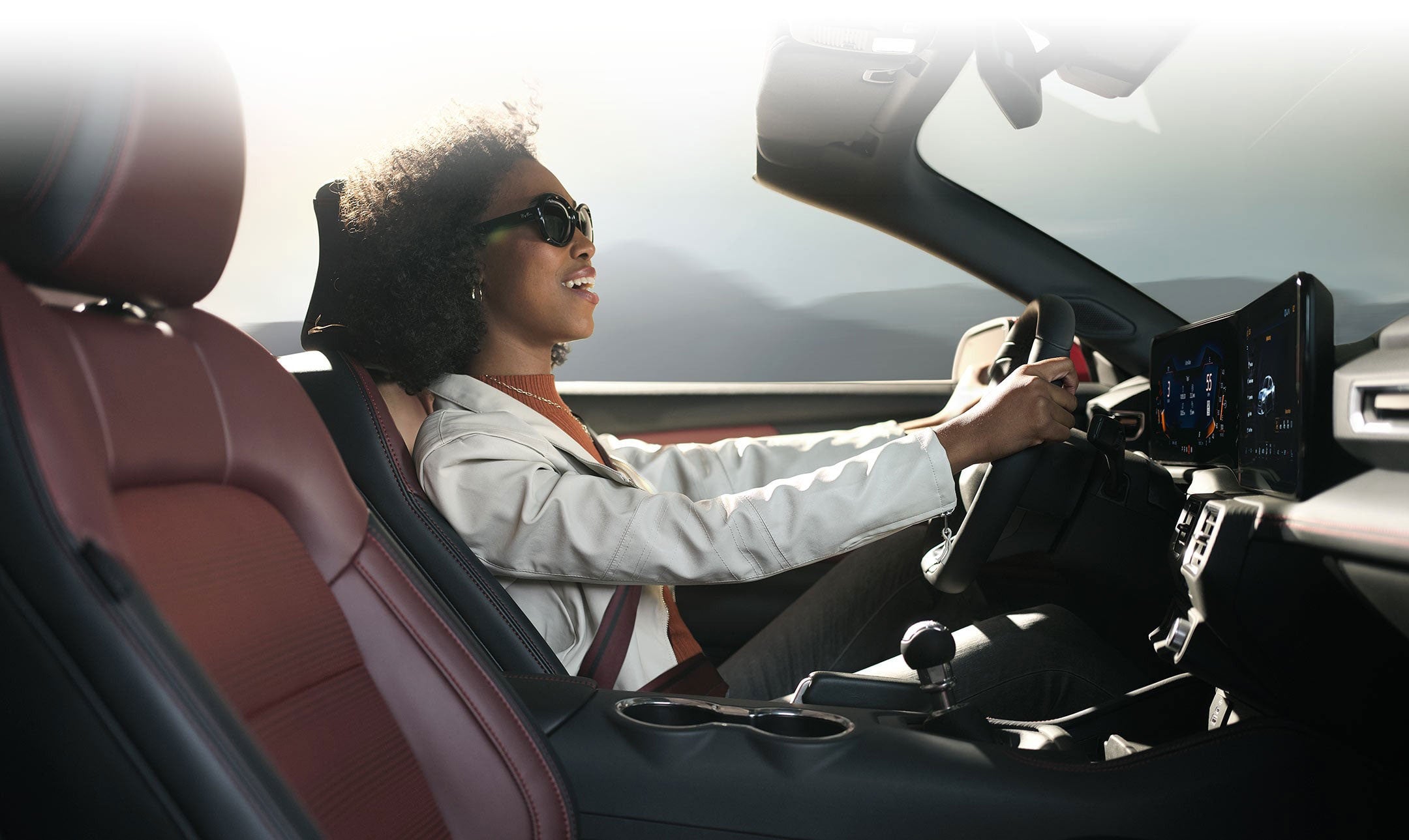 Person sitting in the driver’s seat of a 2024 Ford Mustang® convertible | Al Packer's White Marsh Ford in Middle River MD