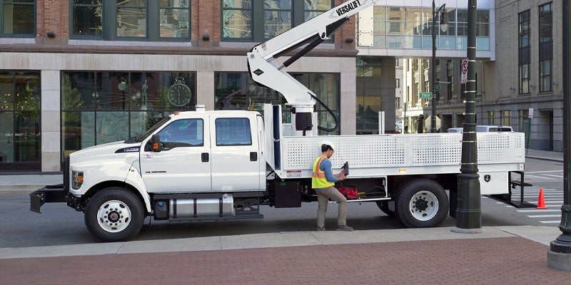 Photo of a worker standing by a 2024 Ford F-650