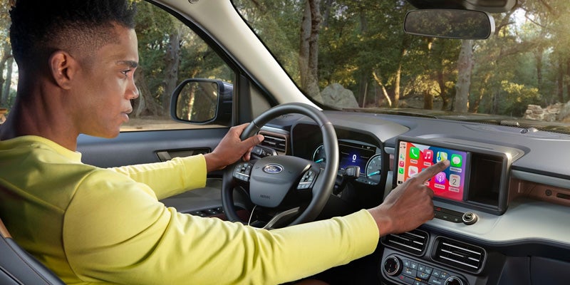 Photo of a person using the touchscreen of a 2025 Ford Maverick
